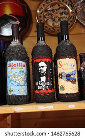 Mount Etna - Italy / July 24, 2019. A Souvenir Of The Cableway Station On Mount Etna: A Bottle Of Wine, On One Picture With The Godfather (Marlon Brando), On The Other Picture The Bottle Is Turned.