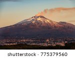 The mount Etna Volcano with smoke and the Catania city, Sicily island, Italy (Sicilia, Italia)