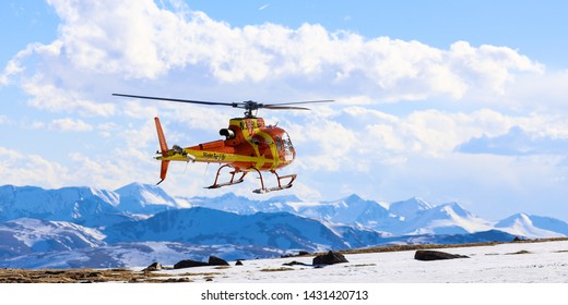 Mount Evans Wilderness, Colorado / USA - June 8, 2019:  Alpine Emergency Flight For Life Rescue Helicopter Landing On The Snow Covered Rocky Mountains