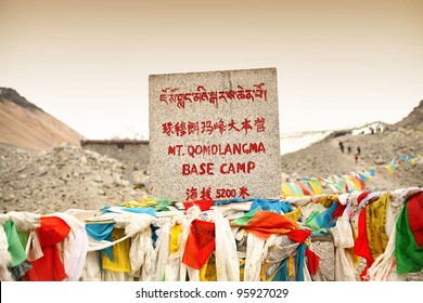 Mount Everest Base Camp Elevation Sign With Prayer Flags In Tibet