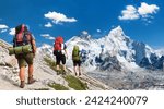 Mount Everest as seen from Kala Patthar and three hikers, way to Mt Everest base camp, Khumbu valley, Sagarmatha national park, Everest area, Nepal Himalayas mountains