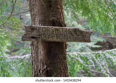 MOUNT FLOYEN, NORWAY - MAY, 2019: Old style wooden pointer signs "Forsigtig kryptonitt" wich translates "Attention Kryptonite"