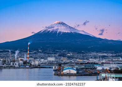 Mount Fuji basked in red glow from the setting sun. Mount Fuji panoramic view of Shizuoka port. - Powered by Shutterstock