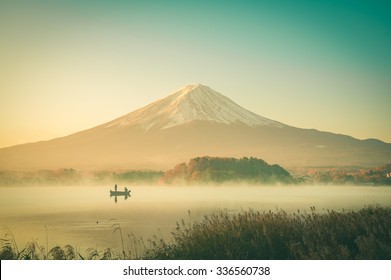 Mount Fuji Landscape In Japan Vintage Tone. People Fishing At Lake Kawaguchiko.