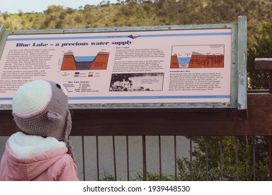 Mount Gambier, SA, Australia - October 06, 2019: Kid reading a sign at the Blue Lake Volcano near Mount Gambier in the Limestone Coast region