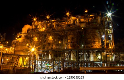 
Mount Isa Mine Processing Plant. Industrial sulphuric acid plant containing 3 stage catalytic conversion, gas cleaning and drying towers, Copper Smelting. Illuminated night shot of acid plant.
