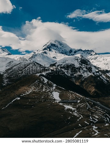 Mount Kazbek with dramatic cloud formations in snowy Georgia.