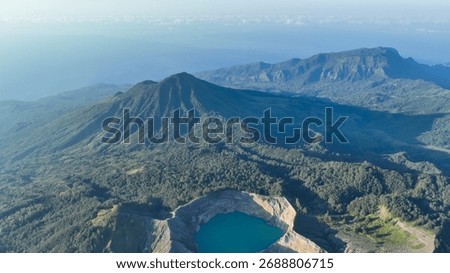 Mount Kelimutu rises dramatically above the forest canopy, guarding the legendary lakes below and capturing the wild heart of Flores.