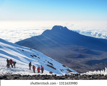 Mount Kilimanjaro - Hikers trudge weary to the summit of the tallest mountain in Africa. 