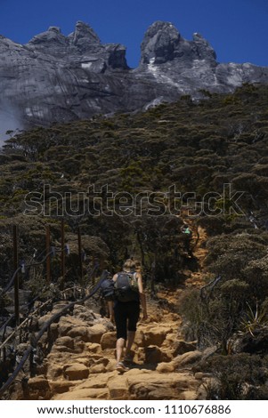 Mount Kinabalu Sabah Malaysia - March 12, 2016:Unidentified climber walking at trail from the summit of Mount Kinabalu the highest mountain in South East Asia.