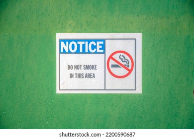 Mount Lemmon  Arizona   Notice and Do Not Smoke in This Area and No Smoking Symbol the sign  Close up signage pasted green wall 