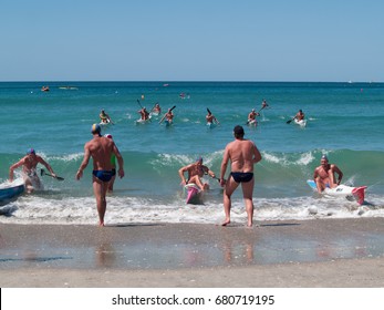 MOUNT MAUNGANUI, NEW ZEALAND - JANUARY 28; Men Involved In Canoe Racing Paddling Through Surf In Competitions At Mount Maunganui, Surf Lifesaving, January 28, 2012, At Mount Maunganui, New Zealand.