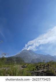 Mount Merapi, an active volcano in Central Java, Indonesia, is known for frequent eruptions and stunning views. At 2,930 meters, it attracts hikers and adventure tourists.