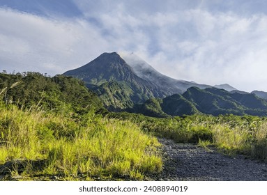 Mount Merapi (peak height 2,930 meters above sea level, as of 2010). Gunung Mêrapi) is a volcano in the central part of Java Island and is one of the most active volcano