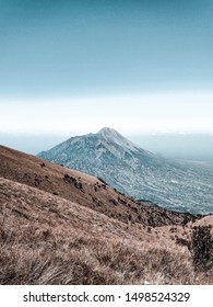 Mount Merapi view from Mount Merbabu. Two beautiful mountains located in Indonesia. Insane savannah with Mount Merapi Landscape.  