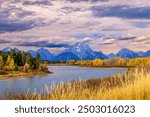 Mount Moran, Grand Tetons Wyoming with the beautiful fall colors at Oxbow Bend in the Snake River with a stormy cloudy sky 