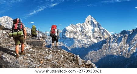 mount Nanda Devi with three hikers, one of the best mounts in Indian Himalaya, seen from Joshimath Auli,  Uttarakhand, India, Indian Himalayas mountains