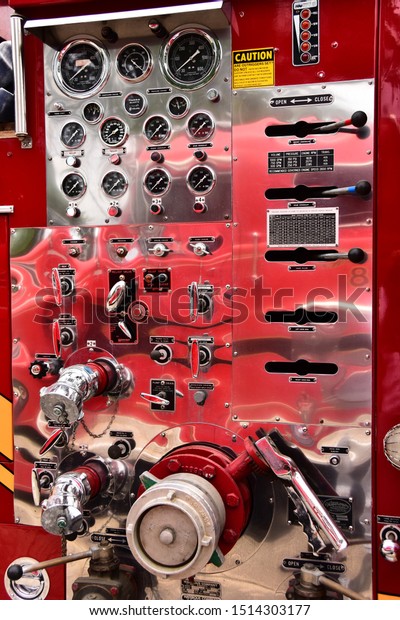 Mount Pleasant, Wisconsin / USA - July 21, 2019:\
Fire engine controls on a firetruck at a local car show in summer. \
The various controls are at easy reaching levels and easy to see in\
vertical view.