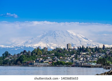 Mount Rainers Seems To Be Right On Top Of A Neighborhood In Tacoma, Washington.