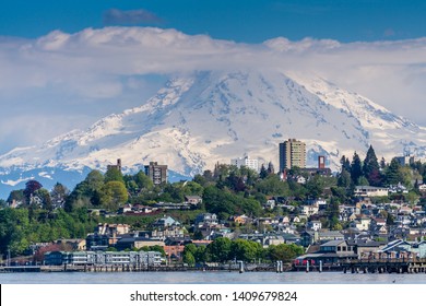 Mount Rainers Seems To Be Right On Top Of A Neighborhood In Tacoma, Washington.