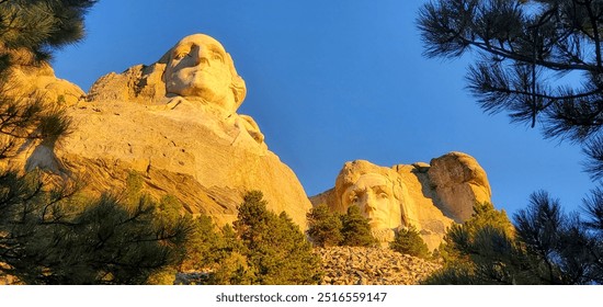 Mount Rushmore in the morning in America with bright sunrise and blue sky. - Powered by Shutterstock