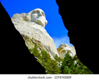 Mount Rushmore through a cavern revealing Washington and Lincoln          