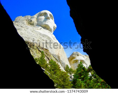 Mount Rushmore through a cavern revealing Washington and Lincoln          