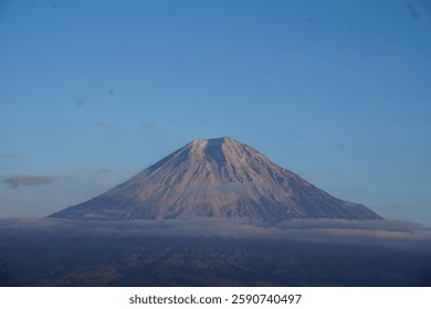 Mount Semeru in East Java, Indonesia is seen in the distance. With clear weather, the sky is blue. This mountain is the highest mountain in Java with an altitude of 3676 Mdpl. 