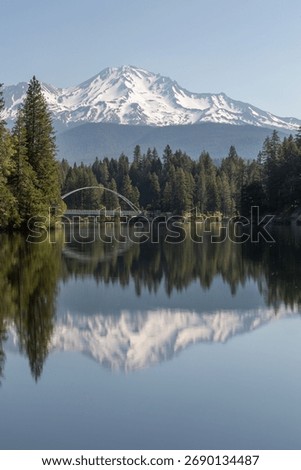 Mount Shasta reflection with an arched bridge in the foreground