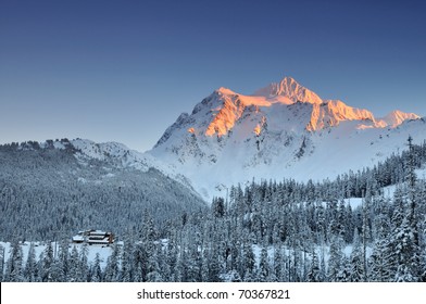 Mount Shuksan Winter Sunset With Ski Lodge At The Foot Of The Mountain