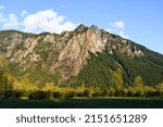 Mount Si rising above the farmalnd in North Bend Washington with the slopes covered in evergreen trees