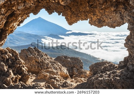 Mount Teide framed by volcanic rocks above the clouds, Tenerife, Canary Islands, Spain
