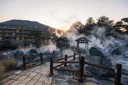 Mount Unzen Hell Valley Jigoku And Hot Springs And Hotel After Sunset With Heavy Gas Steam By Shimabara City, Nagasaki, Kyushu, Japan. Hot Water, Gases And Steam Spout Out Of The Earth
