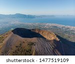 Mount volcano Vesuvius in Napoli. view of the crater of the volcano from above. photo from a drone from the sky. the Apennine Mountains and the city of Pompeii are far in the background. sunny weather