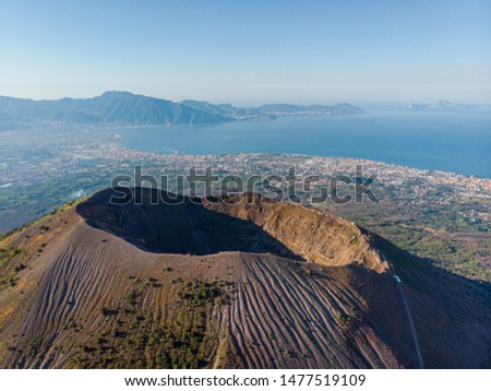 Mount volcano Vesuvius in Napoli. view of the crater of the volcano from above. photo from a drone from the sky. the Apennine Mountains and the city of Pompeii are far in the background. sunny weather