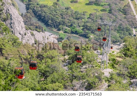Mountain Ascension: The cable car glides along, revealing Antalya's panoramic landscape as it ascends Tunektepe Mountain, a captivating travel experience. Stock photo © 
