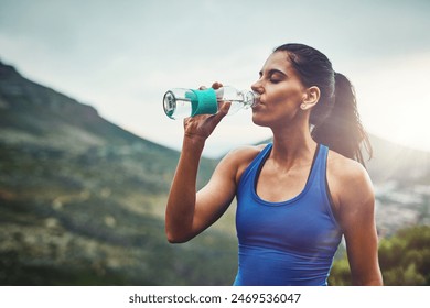 Mountain, athlete or woman drinking water on break to hydrate or relax for healthy energy in exercise. Tired, fatigue and thirsty girl runner with liquid or fitness in marathon training or workout - Powered by Shutterstock