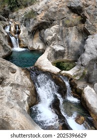 A Mountain Azure River Among Stones With Waterfalls