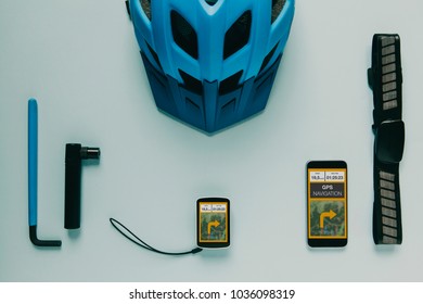 Mountain bike cycling computer gps, mobile phone and accessories on blue background.