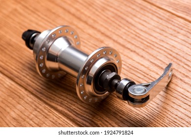 Mountain bike front hub bushing isolated on wooden background. Bicycle components. Cycling equipment. - Powered by Shutterstock