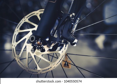 Mountain bike front wheel with mechanical disc marriage. Part of Mountain Bike brake in close up.