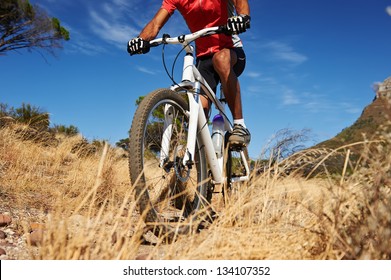 mountain bike man with blue sky riding on outdoor trail in nature - Shutterstock ID 134107352
