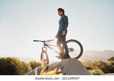 Mountain Bike Or Motorcycle Cyclist On Rock For Marathon Goal, Sports Adventure Or Outdoor Travel With Sunglasses And Helmet. Fitness Training Man With Bicycle On A Hill Blue Sky Mockup In Australia