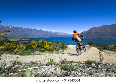 Mountain Bike Rider On Bike Path In Queenstown, New Zealand