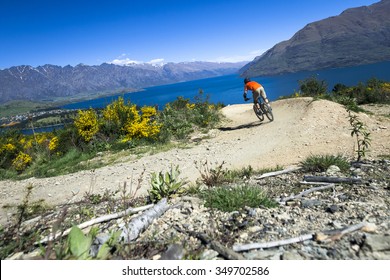 Mountain Bike Rider On Bike Path In Queenstown, New Zealand