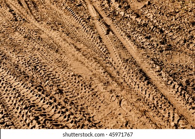 Mountain Bike Tracks In Mud Background