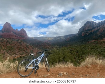 Mountain bike with a view of red rock formations in a canyon with mountains on a cloudy day - Powered by Shutterstock