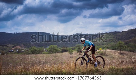 Mountain biker cyclists training Mountain trail
