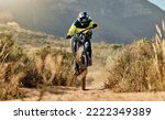 Mountain biker, dirt bike and dessert rider cycling on sports bicycle on nature path, dirt road and extreme sport performance. Adventure race competition, outdoor racer and cycling in Australia sand