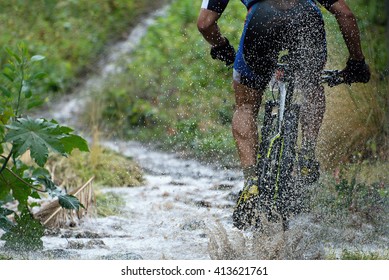 Mountain Biker Driving In Rain Upstream Creek